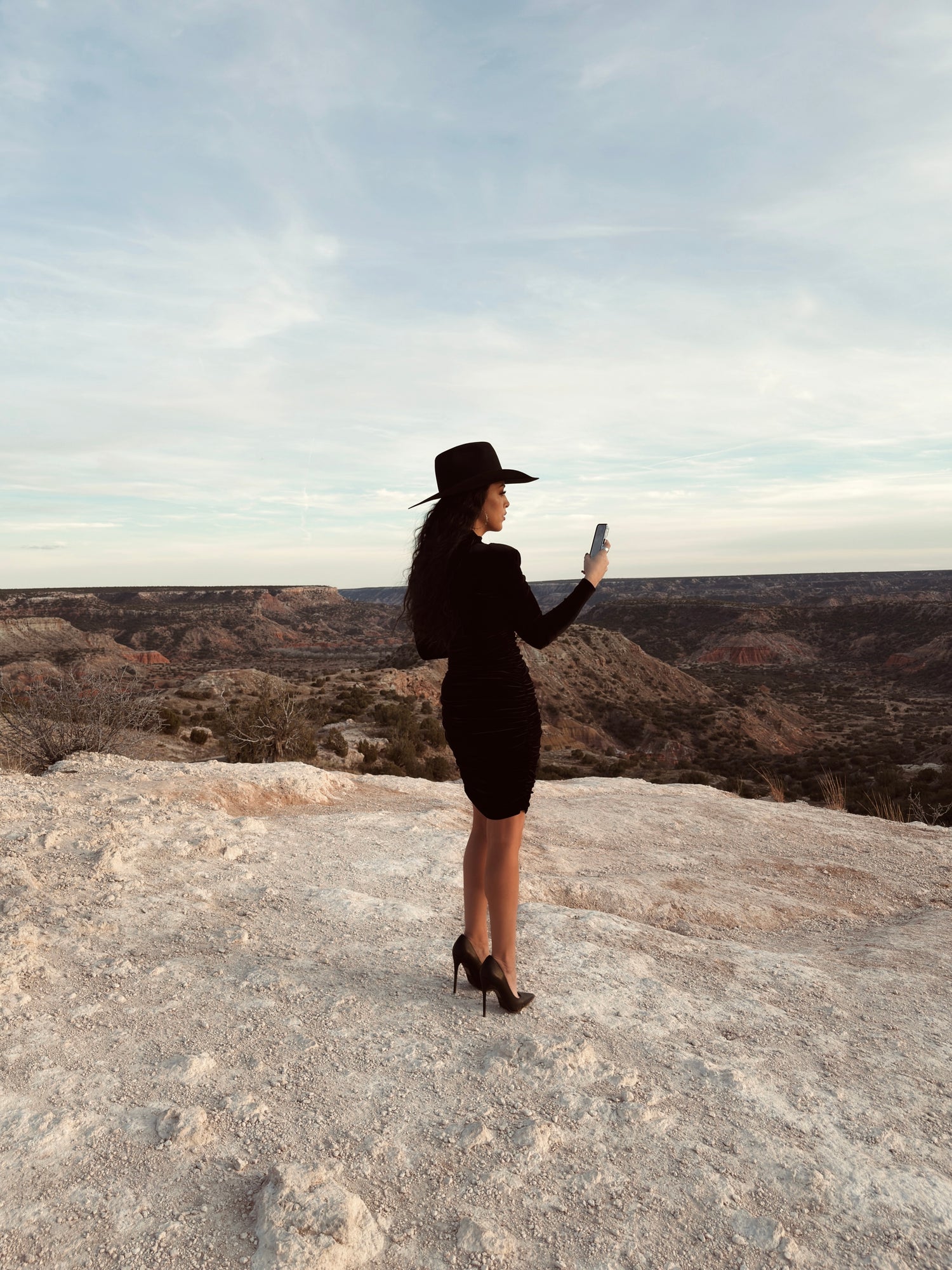Marketing consultant reviewing digital strategy while standing on canyon overlook, representing brand strategy, marketing audits, and business growth consulting by LW Haus of Marketing