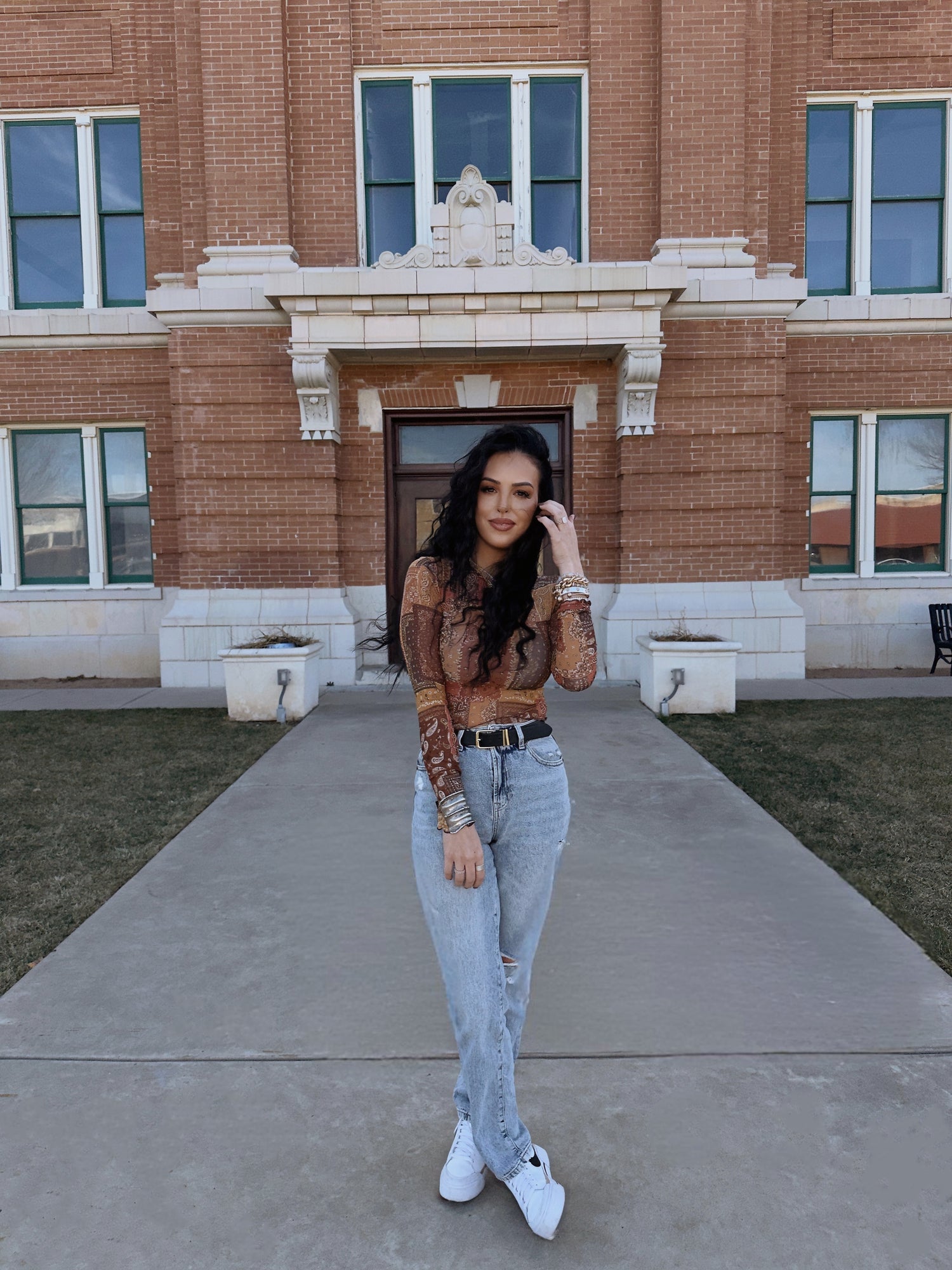 Leah Williams, a creative marketing professional and owner of LW Haus of Marketing, standing in front of the historic Randall County courthouse in Canyon, Texas.